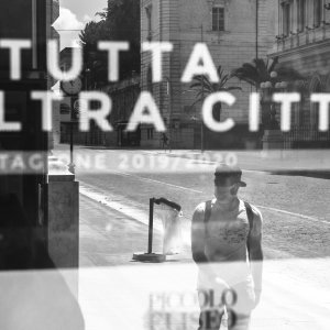 ROME - April 27, 2020: a man wanders the central via Nazionale the image reflected on a window of the Eliseo theater which indicates a “completely different city”